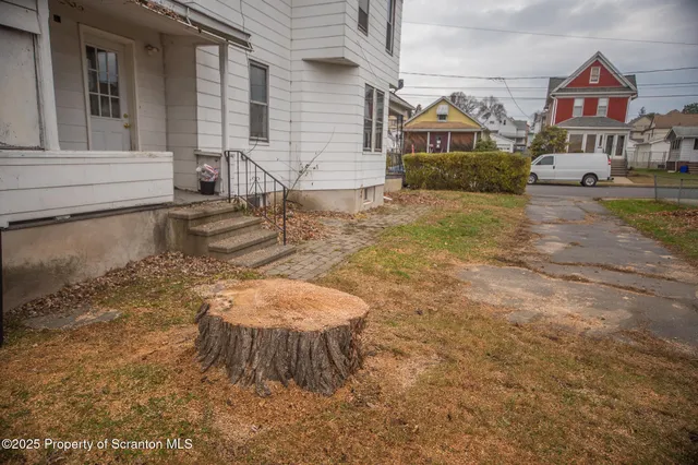 a kitchen with stainless steel appliances granite countertop a stove a refrigerator a white table and chairs