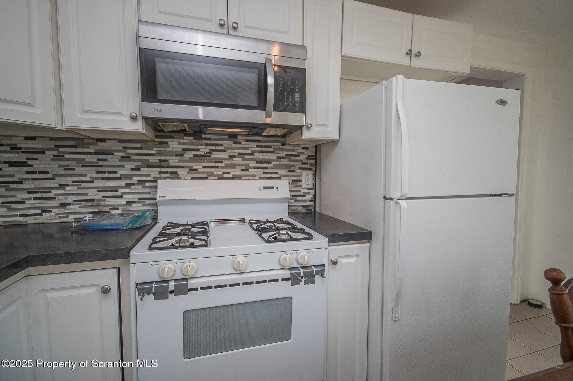 1227 Rundle Street Scranton, PA 18504 - Photo 27 of 43 a kitchen with a stove and a microwave