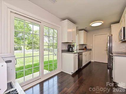 a kitchen with a refrigerator a sink and a large window
