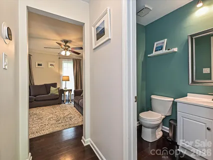 a bathroom with a toilet and a mirror