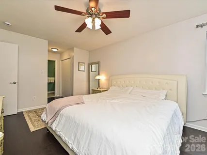a bedroom with a large bed and a chandelier