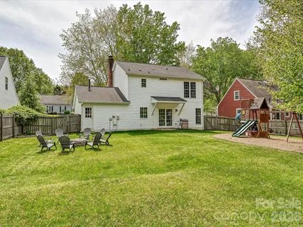 a view of a house with a yard patio and sitting area