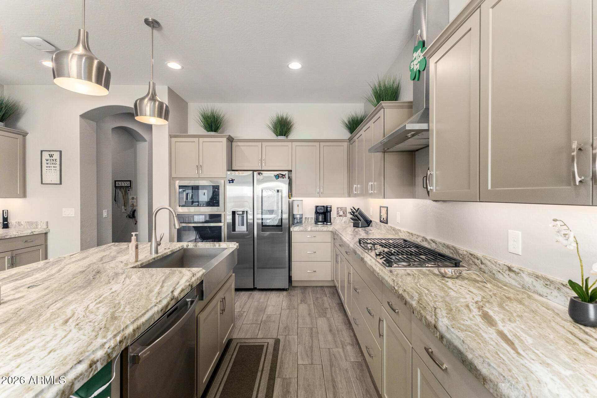 23135 East Thornton Road Queen Creek, AZ 85142 - Photo 15 of 61 a kitchen with granite countertop a stove a sink dishwasher and a refrigerator with wooden floor