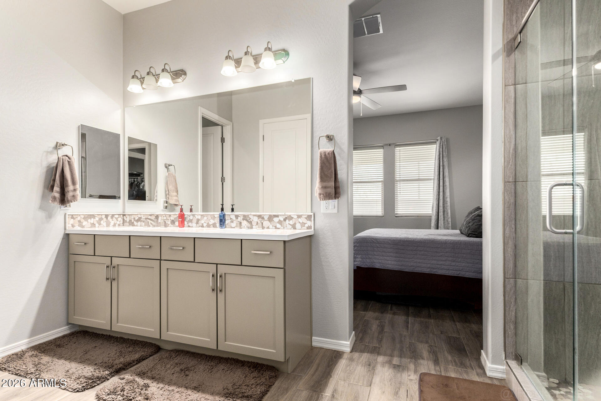 23135 East Thornton Road Queen Creek, AZ 85142 - Photo 24 of 61 a en suite bathroom with a double vanity sink a mirror and a bathtub