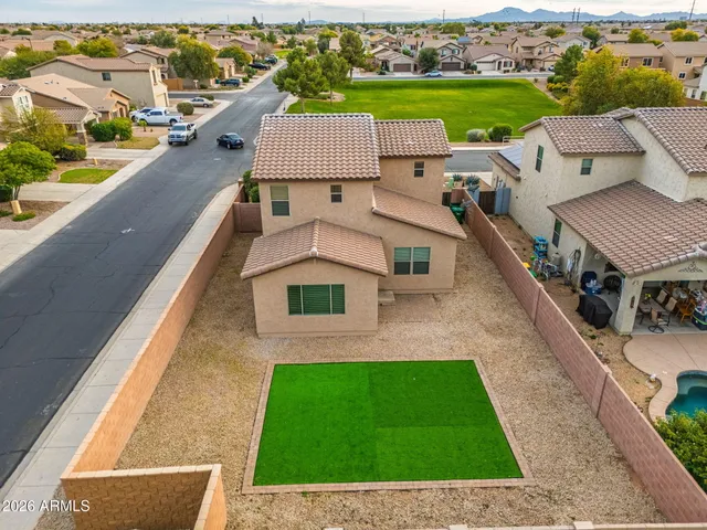 an aerial view of a house with a garden and lake view
