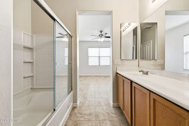 a bathroom with a double vanity sink and a mirror