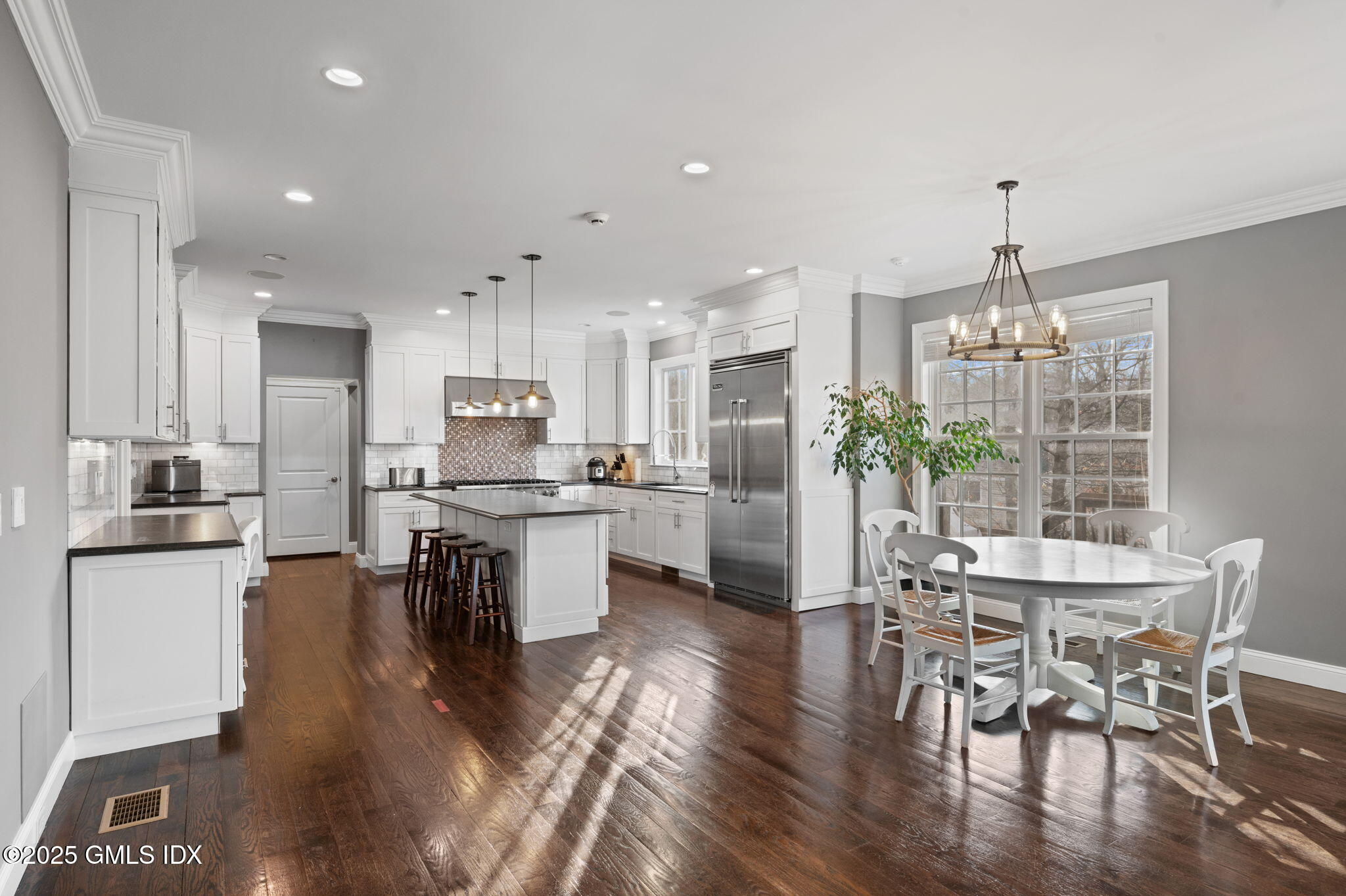 12 Cognewaugh Road Cos Cob, CT 06807 - Photo 16 of 48 a kitchen with a dining table chairs stainless steel appliances and cabinets