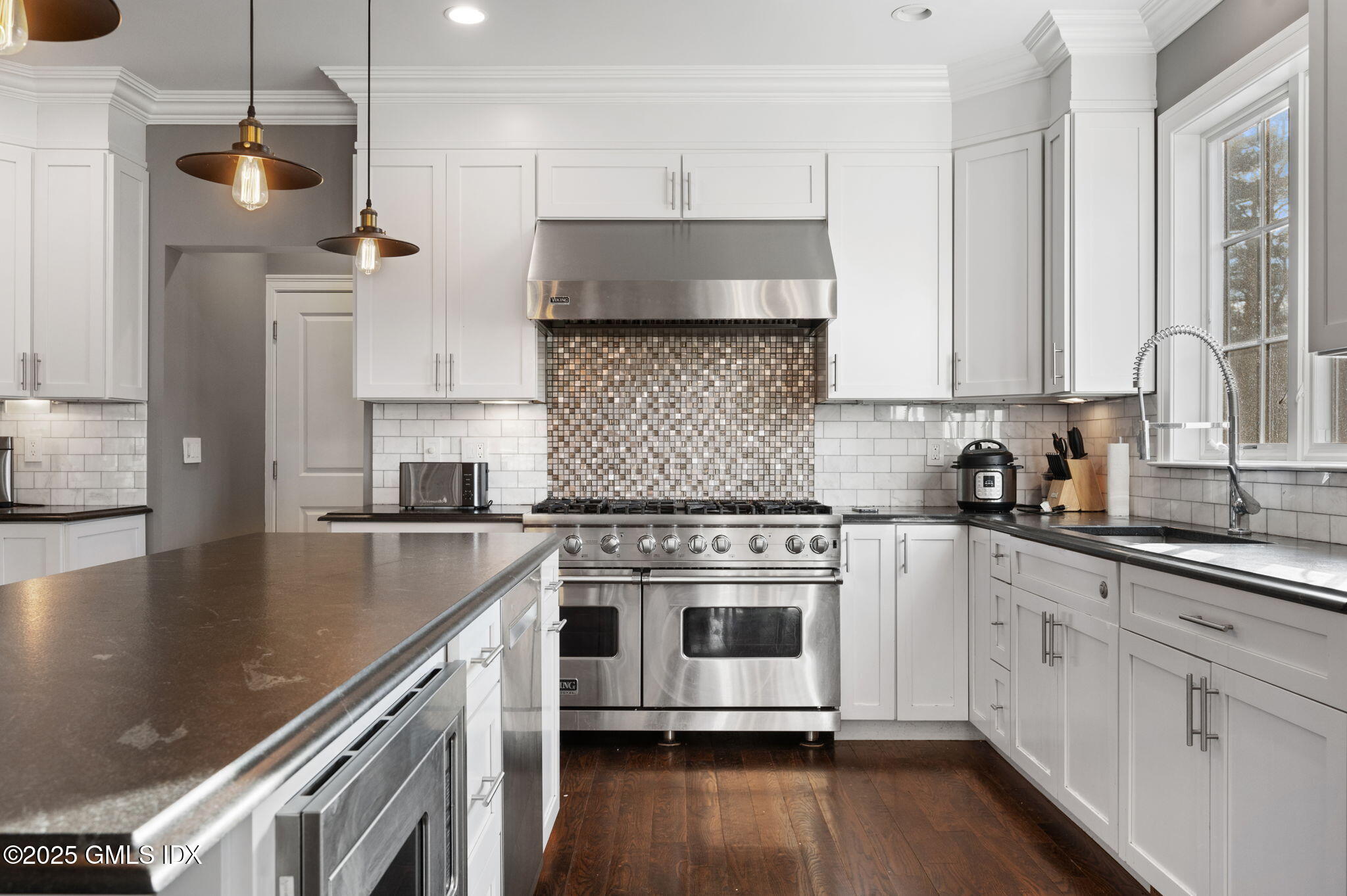 12 Cognewaugh Road Cos Cob, CT 06807 - Photo 17 of 48 a kitchen with stainless steel appliances white cabinets a sink and a stove