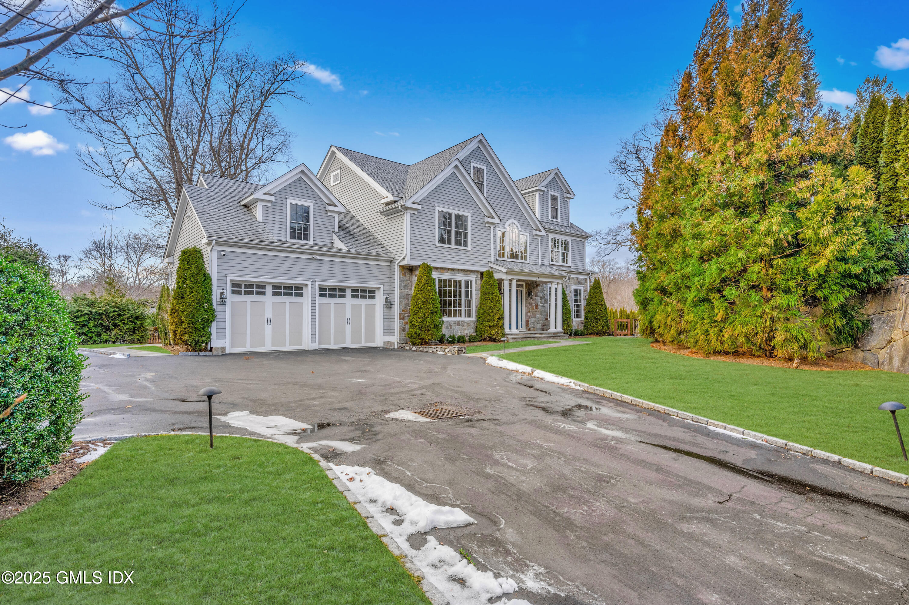 12 Cognewaugh Road Cos Cob, CT 06807 - Photo 2 of 48 a view of a white house next to a yard with big trees