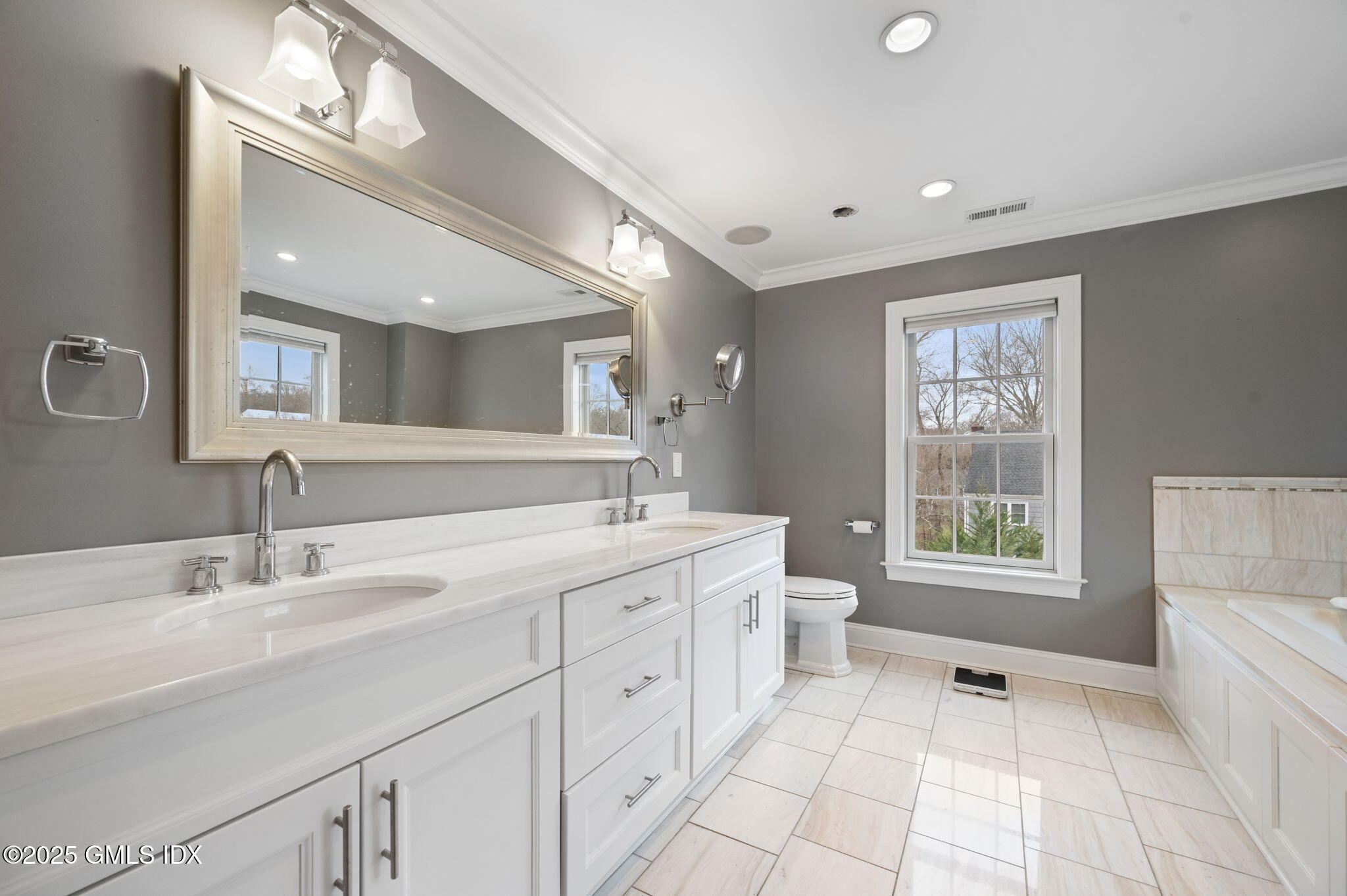 12 Cognewaugh Road Cos Cob, CT 06807 - Photo 26 of 48 a spacious bathroom with a double vanity sink a mirror and a bathtub