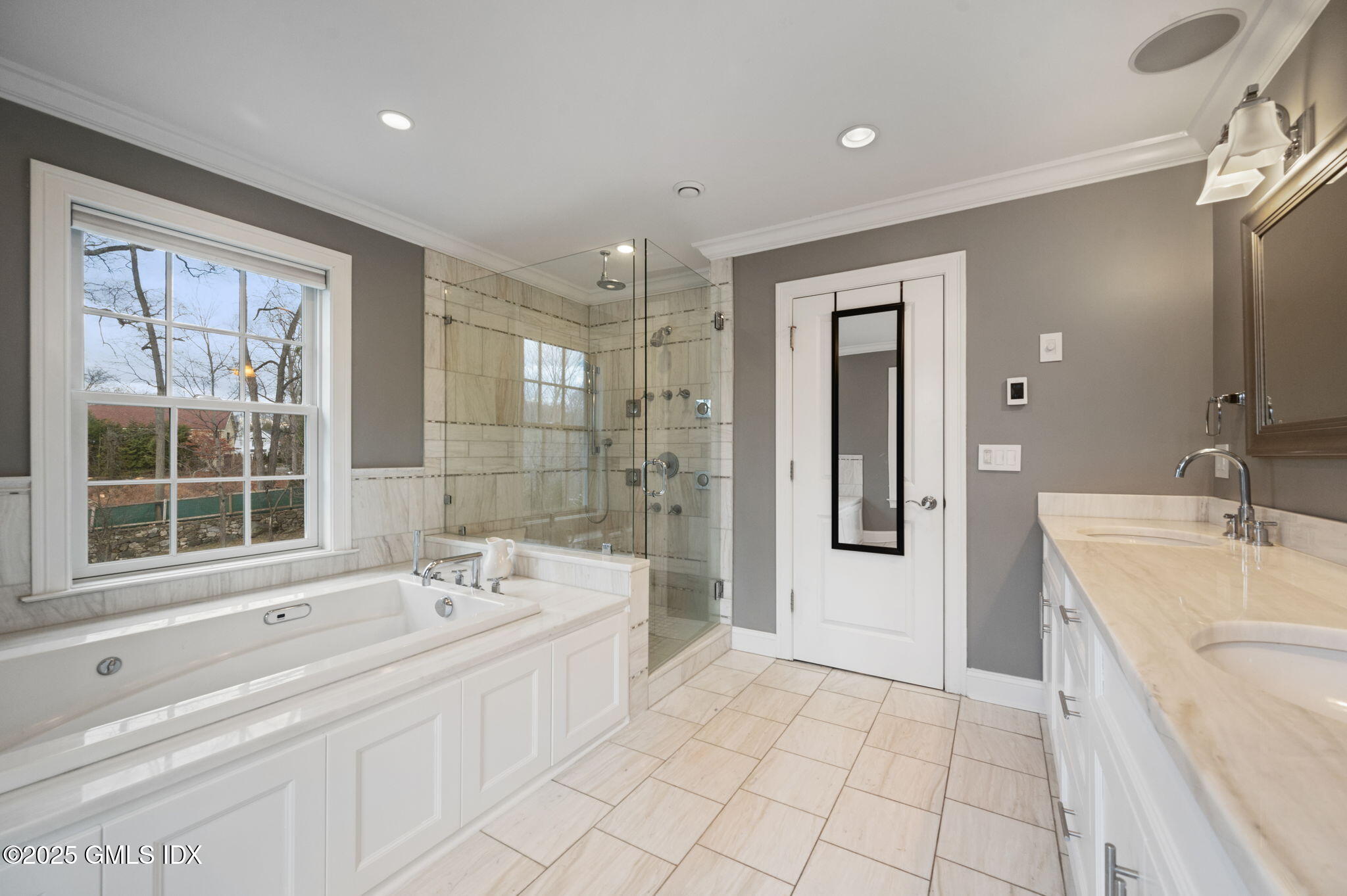 12 Cognewaugh Road Cos Cob, CT 06807 - Photo 27 of 48 a bathroom with a tub a sink and mirror