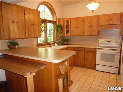 6379 Five Springs Road Shavertown, PA 18708 - Photo 9 of 35 a kitchen with a sink a stove and white cabinets