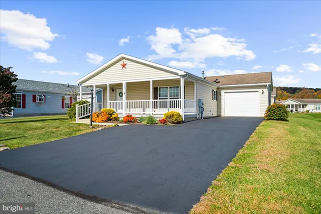 a view of a house with backyard and a patio