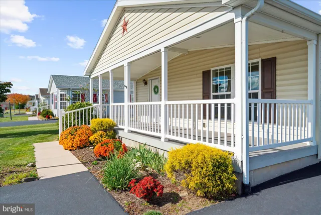 a view of a house with wooden fence