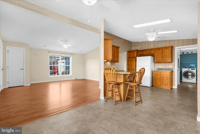a view of a dining room with furniture and a kitchen
