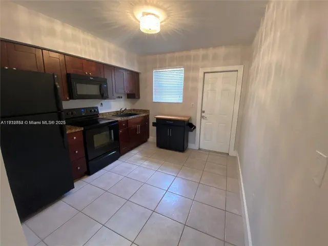 a kitchen with stainless steel appliances a sink and a stove top oven