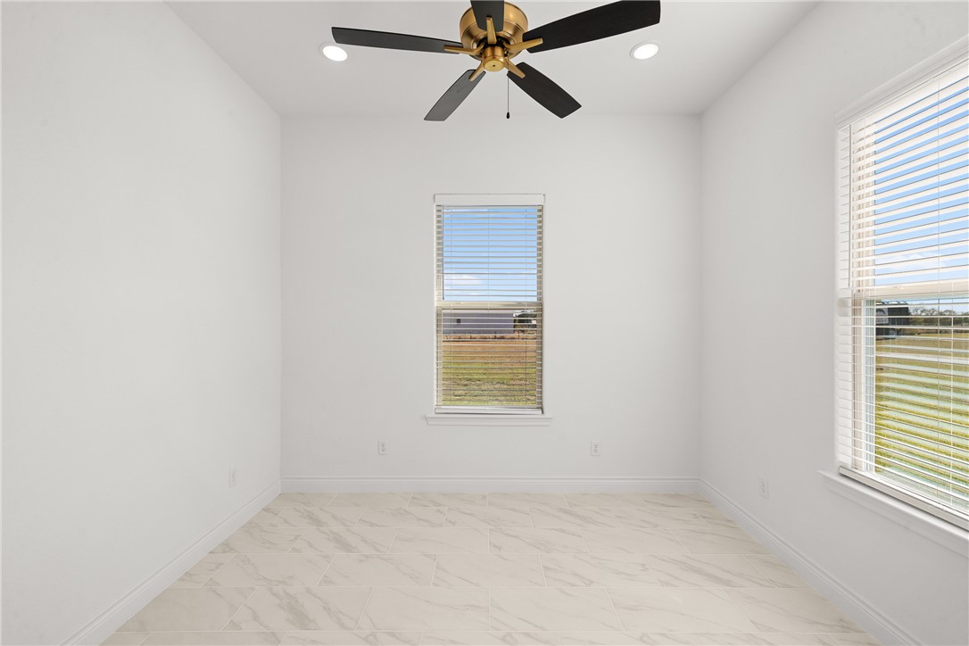 6512 Agave Court Bryan, TX 77808 - Photo 23 of 42 Spare room featuring healthy amount of natural light, recessed lighting, light marble finish floors, and a ceiling fan