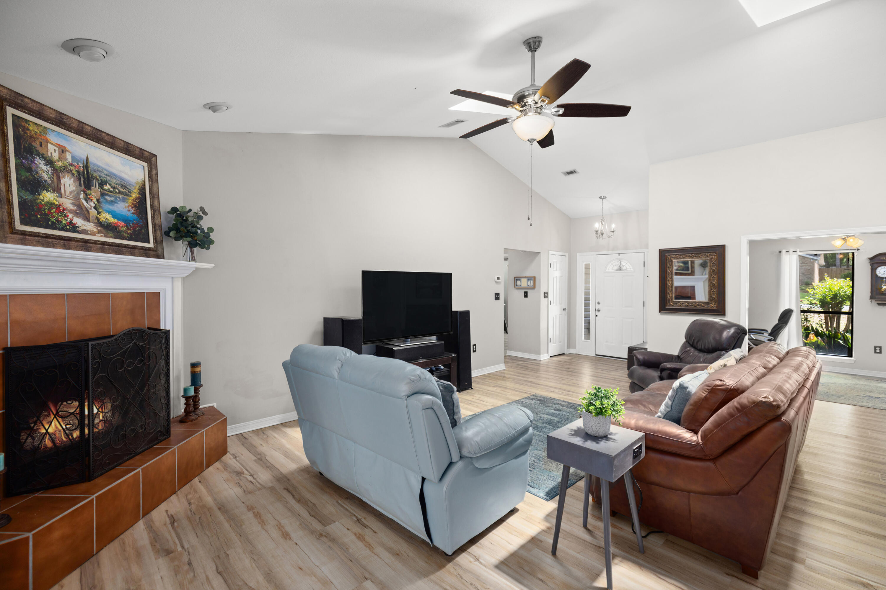 314 Ruckel Drive Niceville, FL 32578 - Photo 15 of 66 a living room with furniture a fireplace and a flat screen tv