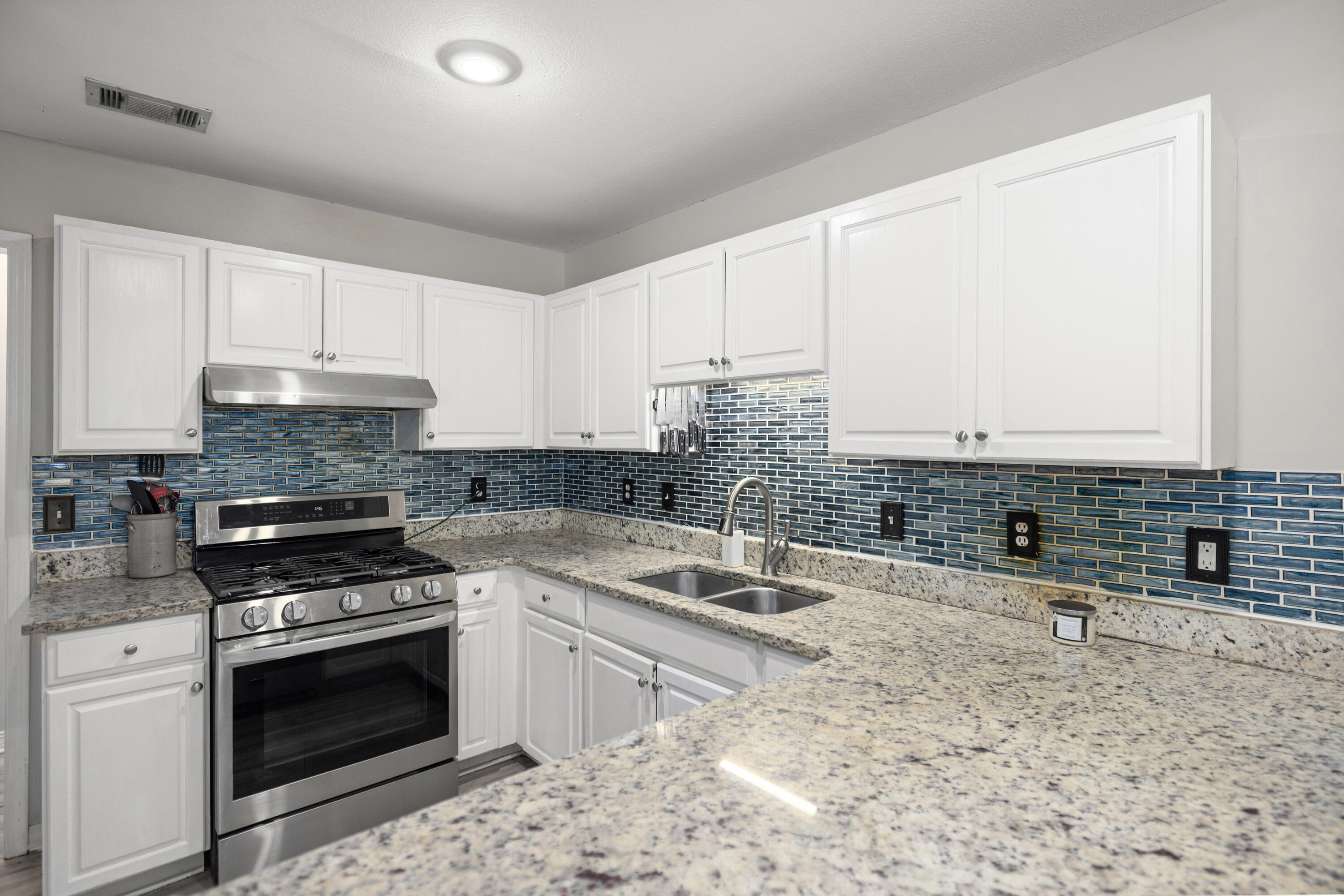 314 Ruckel Drive Niceville, FL 32578 - Photo 21 of 66 a kitchen with granite countertop a sink stove and cabinets