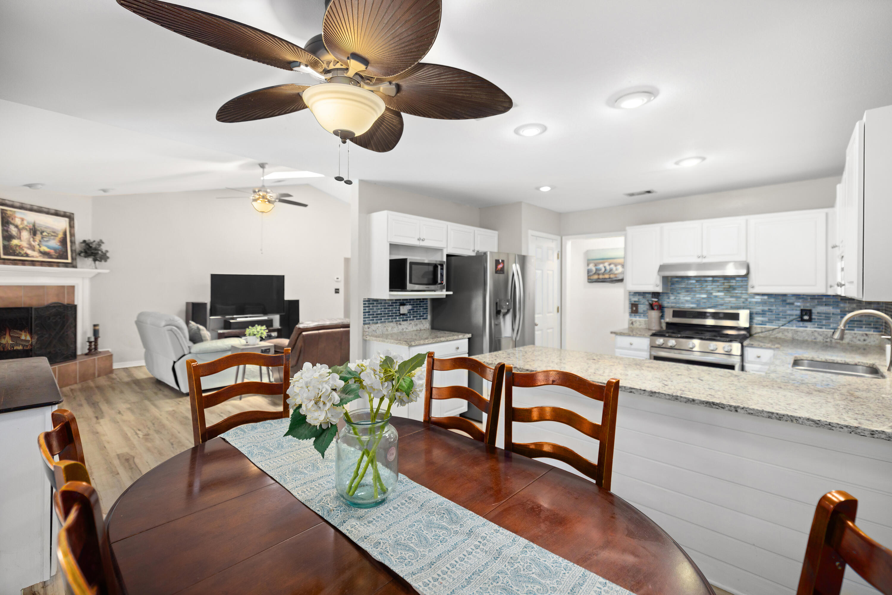 314 Ruckel Drive Niceville, FL 32578 - Photo 26 of 66 a living room with furniture a fireplace and a flat screen tv