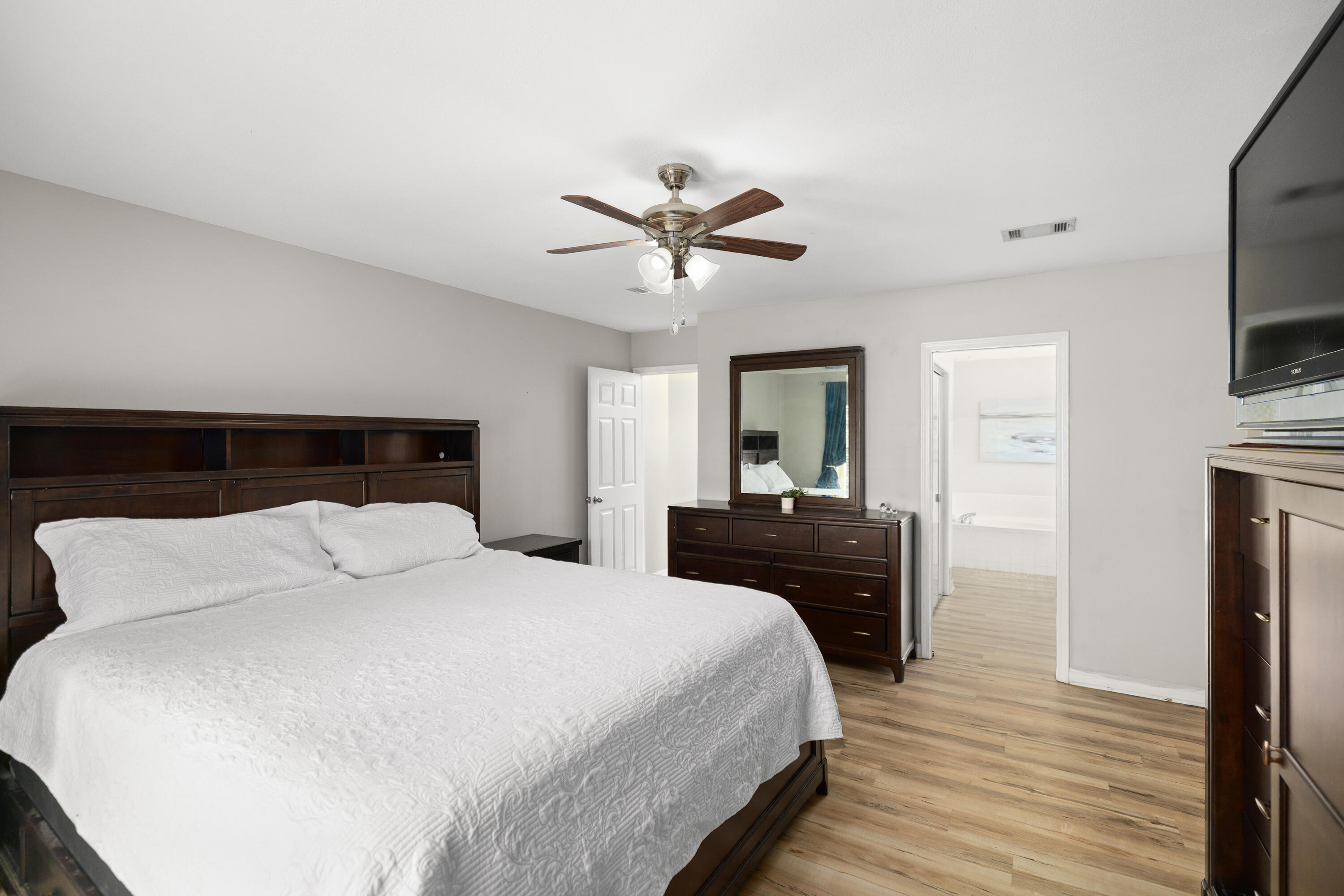 314 Ruckel Drive Niceville, FL 32578 - Photo 31 of 66 a bedroom with a bed and a chandelier