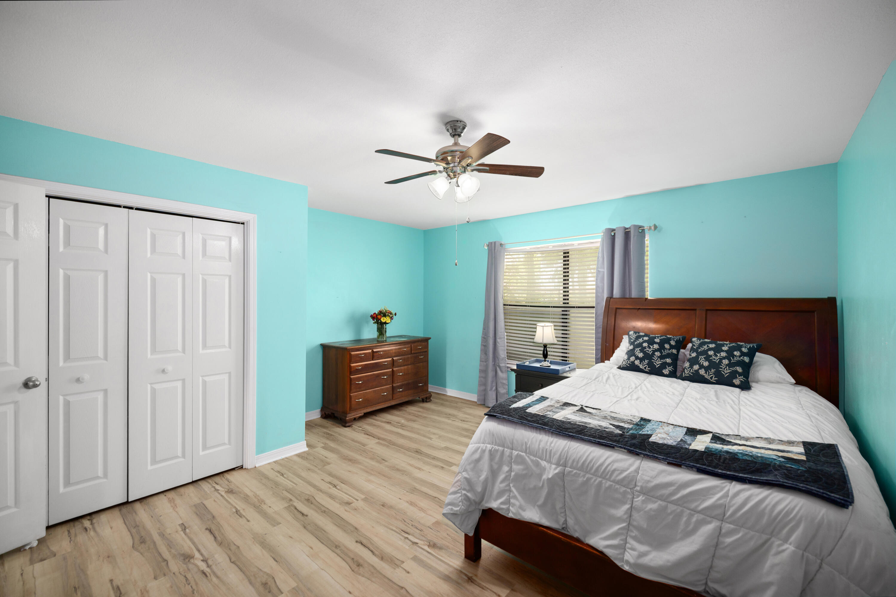 314 Ruckel Drive Niceville, FL 32578 - Photo 38 of 66 a bedroom with a bed and a chandelier