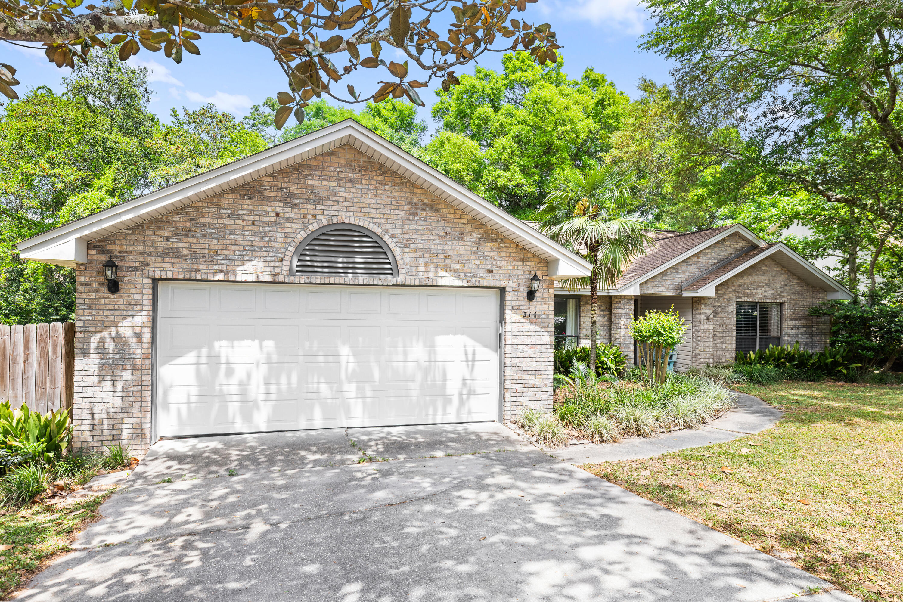 314 Ruckel Drive Niceville, FL 32578 - Photo 4 of 66 a front view of a house with a yard and garage