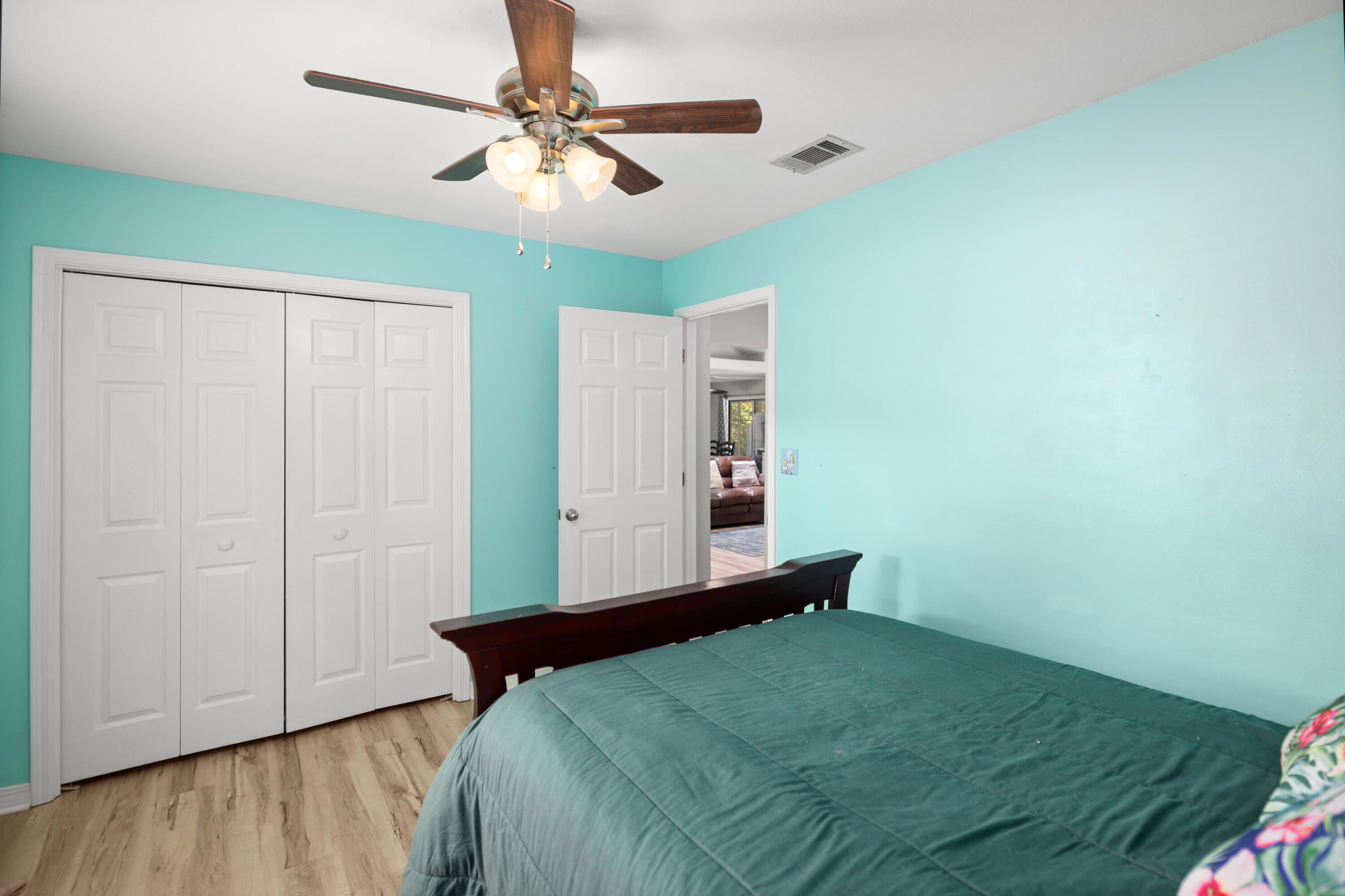 314 Ruckel Drive Niceville, FL 32578 - Photo 43 of 66 a bedroom with a bed and a chandelier fan