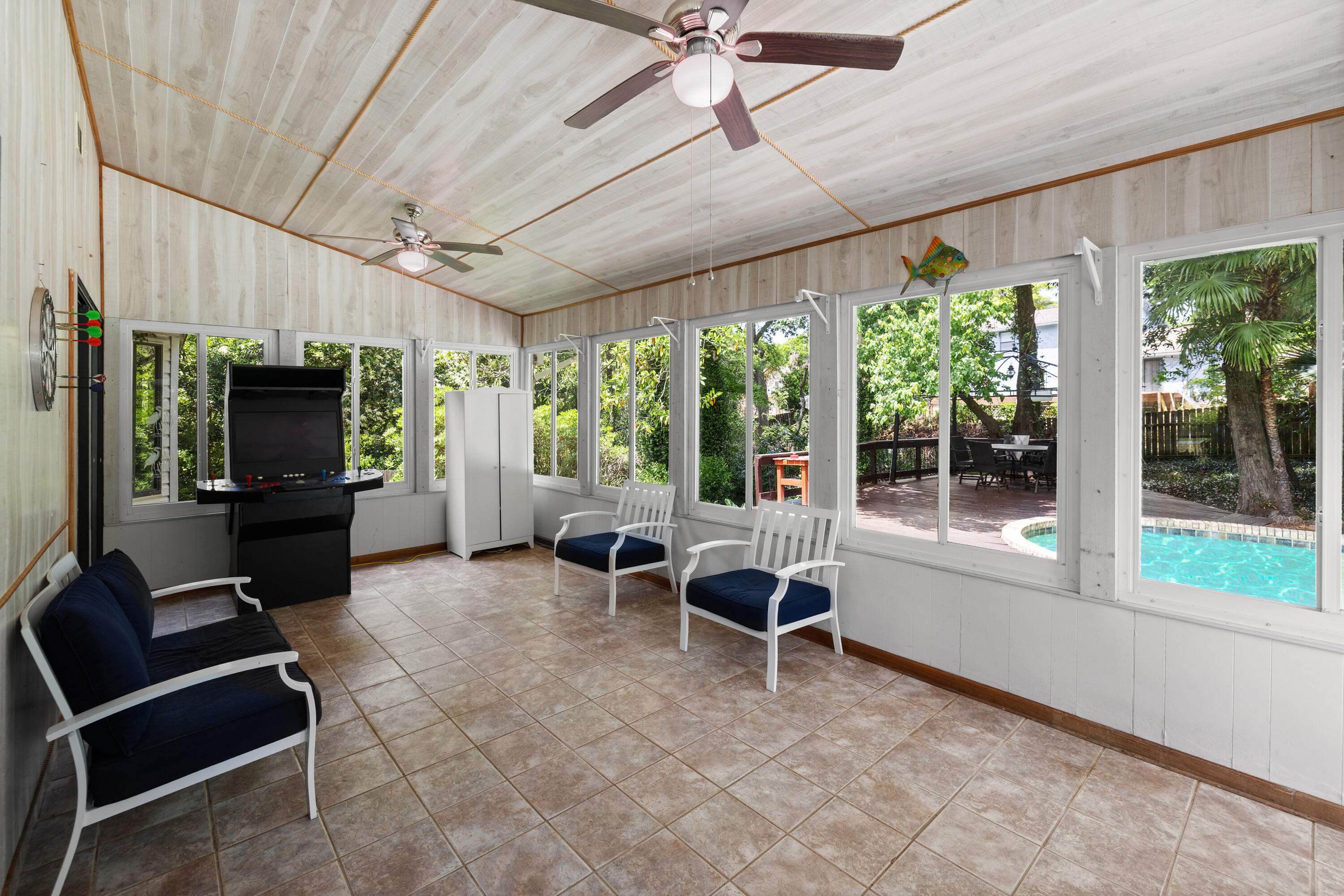 314 Ruckel Drive Niceville, FL 32578 - Photo 47 of 66 a living room with furniture a flat screen tv and a floor to ceiling window