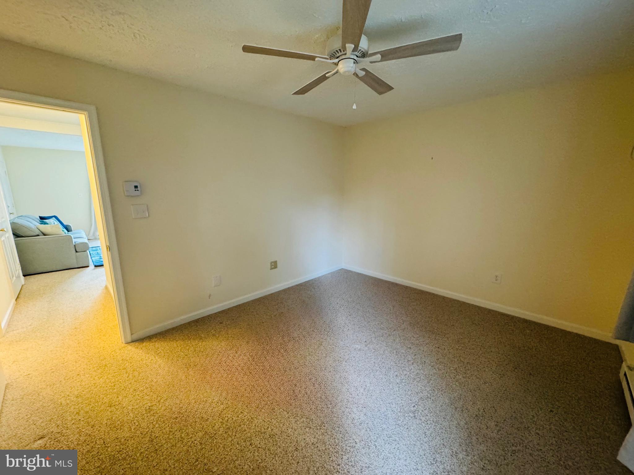 14400 Jarvis Avenue, Unit 113C Ocean City, MD 21842 - Photo 12 of 19 an empty room with a fan and a window