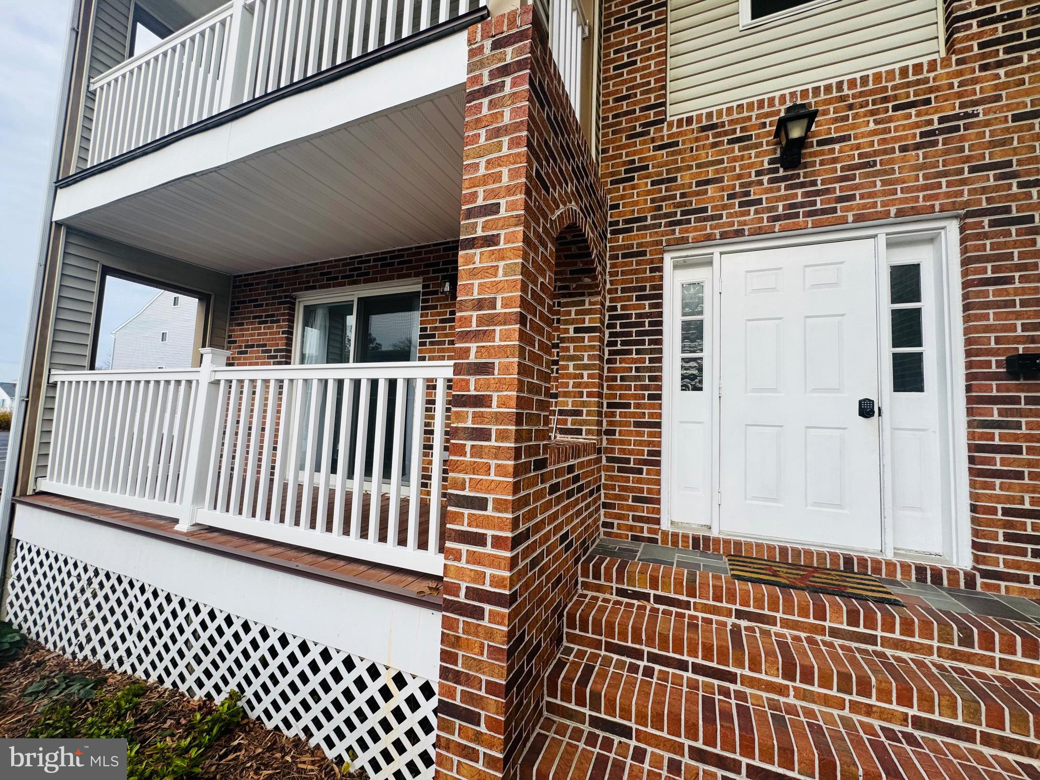 14400 Jarvis Avenue, Unit 113C Ocean City, MD 21842 - Photo 2 of 19 a view of a brick house with a large window