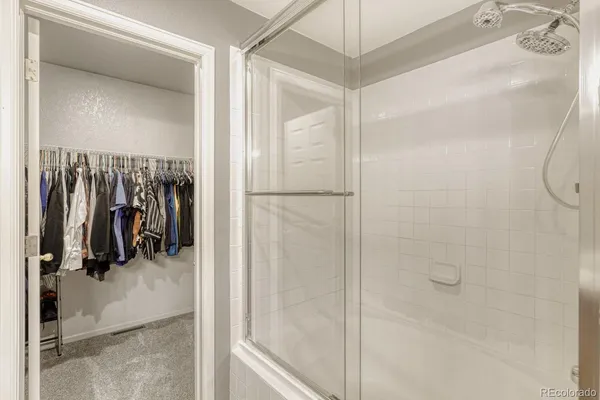 a view of a walk in closet and a bathroom