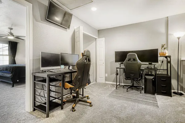 a view of a workspace with furniture and a flat screen tv