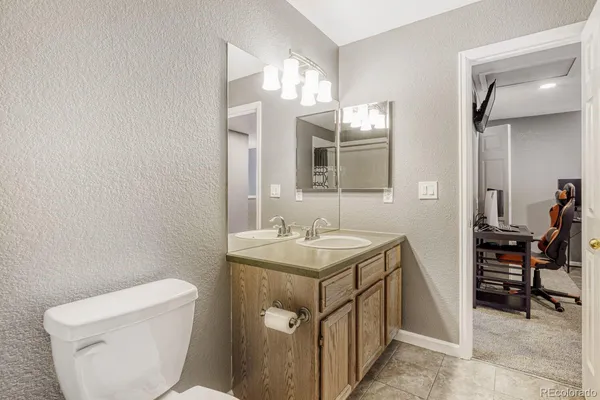 a bathroom with a toilet sink and mirror