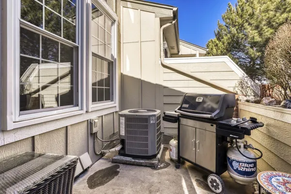 a view of a chairs and table in the back of a house