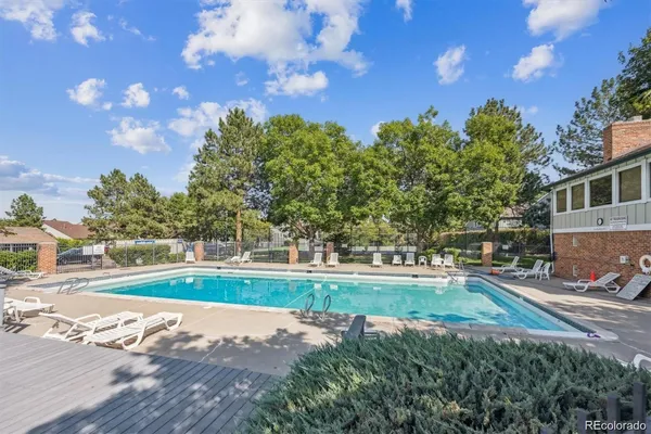 a view of a swimming pool and trees in the background