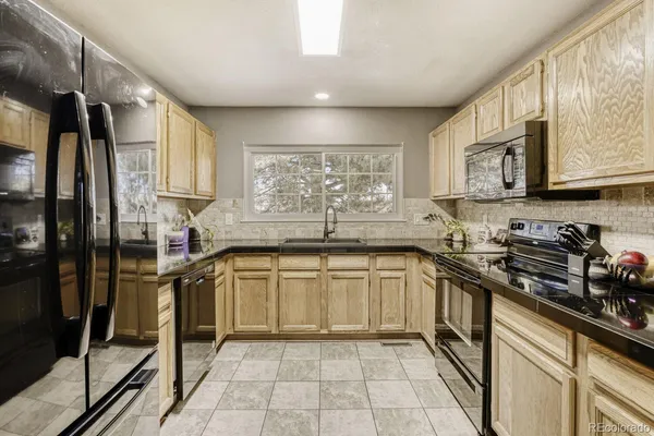 a kitchen with a sink window and cabinets