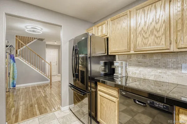 a kitchen with stainless steel appliances a sink and a refrigerator