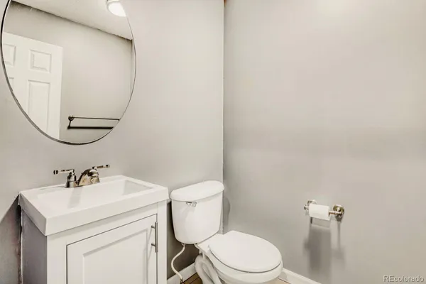 a bathroom with a sink mirror and toilet