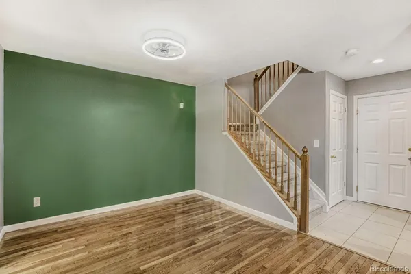 a view of a hallway with wooden floor and entryway