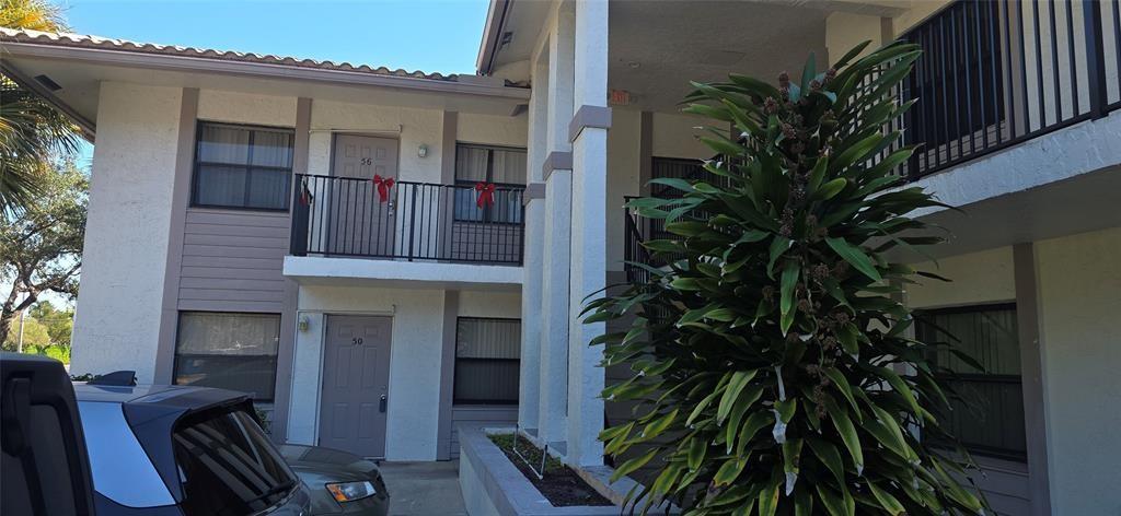 a building with potted plants in front of door