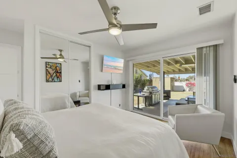 a bedroom with a large bed and a large window