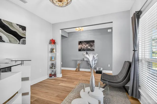 a view of kitchen with granite countertop sink and natural light