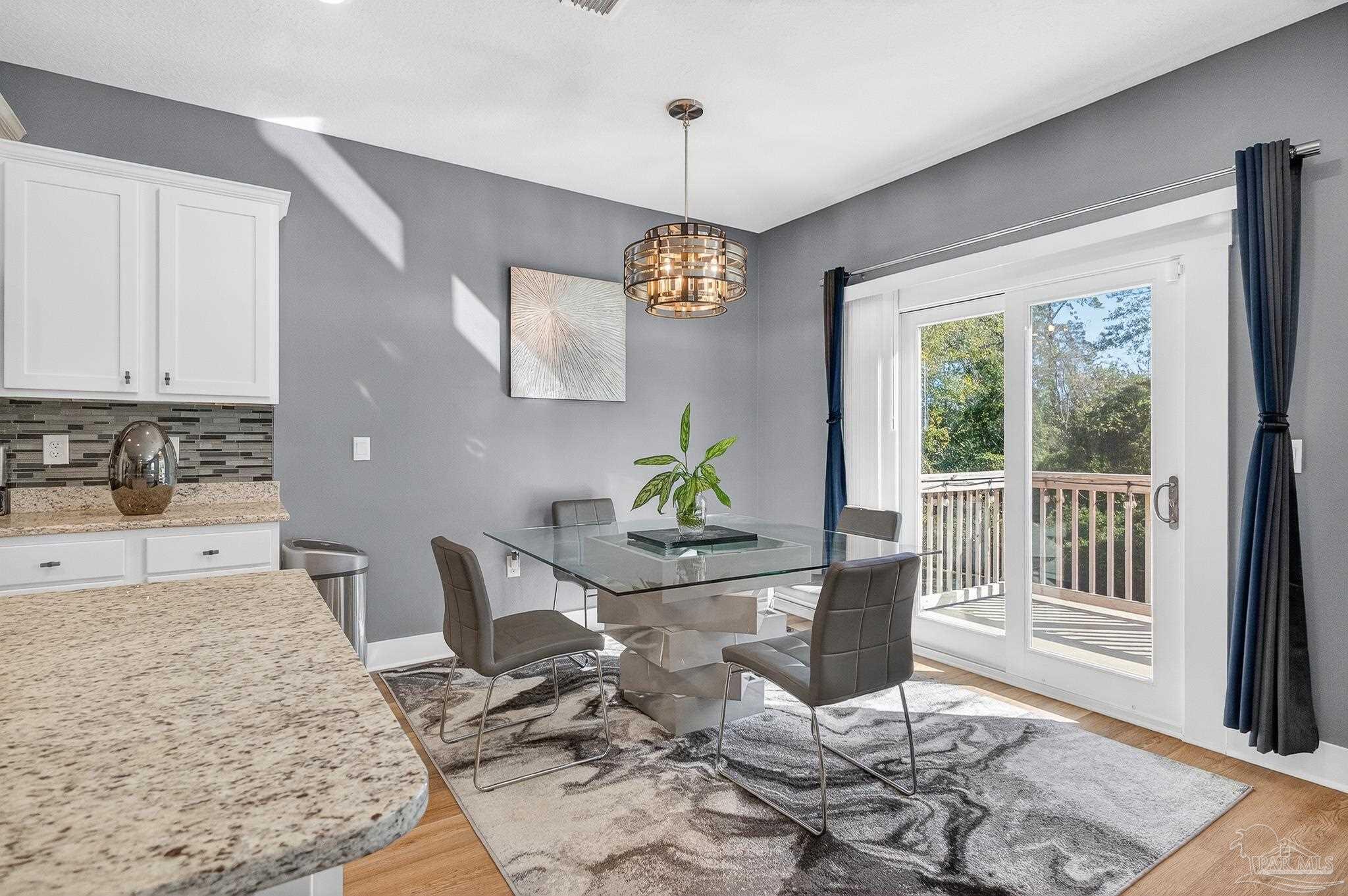 6076 Rutherford Loop Pensacola, FL 32526 - Photo 20 of 67 a view of a dining room with furniture window and wooden floor