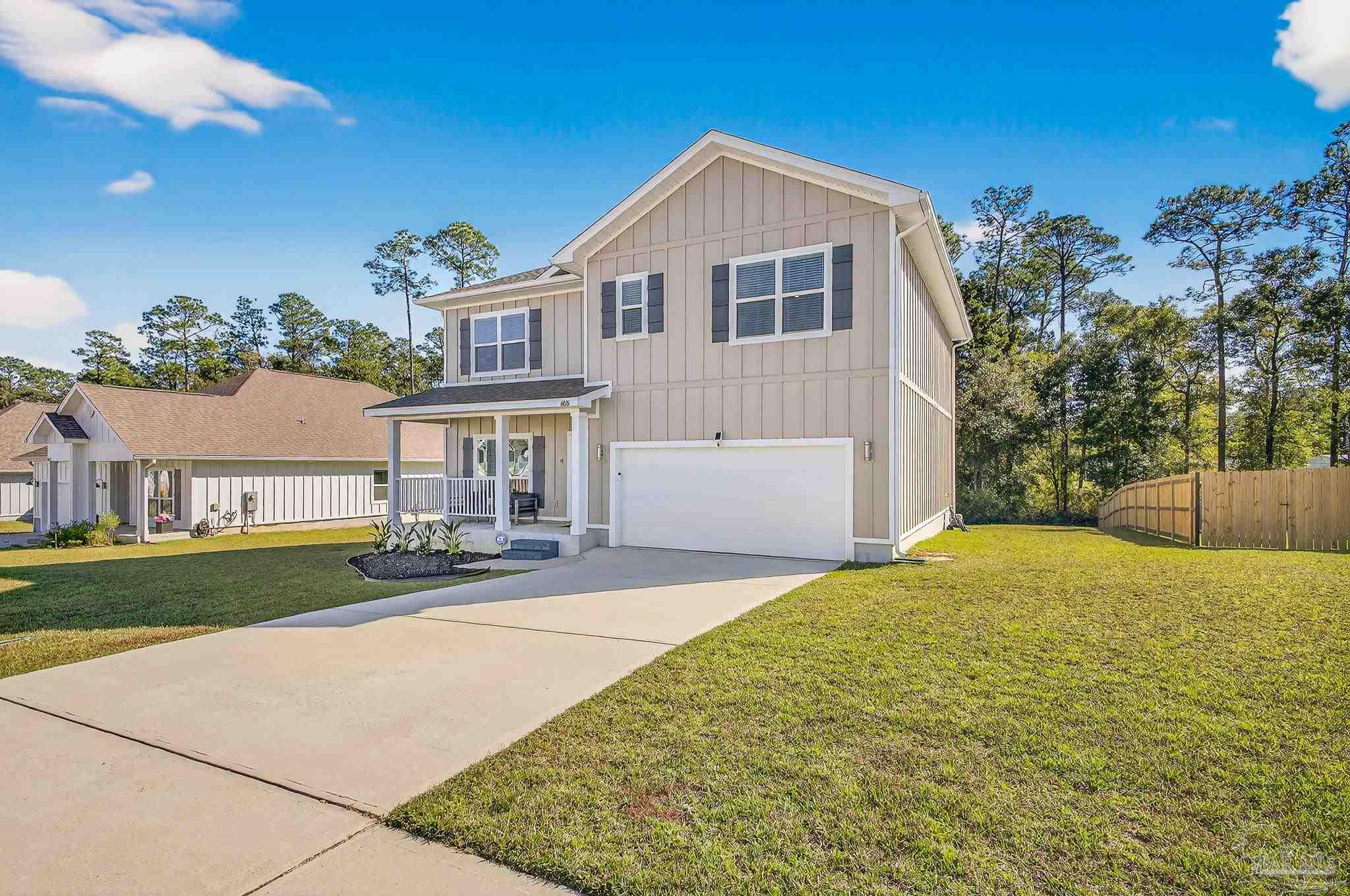 6076 Rutherford Loop Pensacola, FL 32526 - Photo 2 of 67 a front view of a house with yard and green space