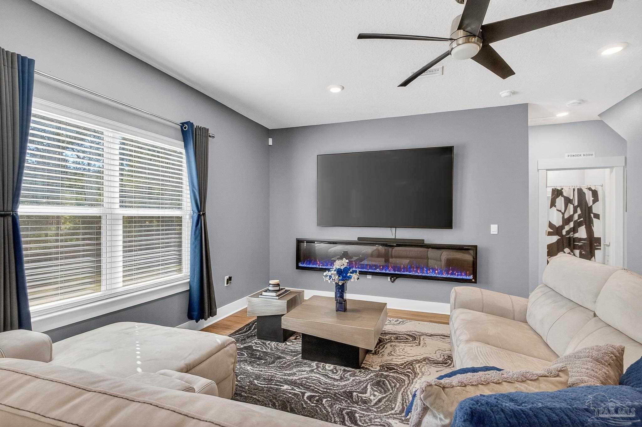 6076 Rutherford Loop Pensacola, FL 32526 - Photo 24 of 67 a living room with furniture and a flat screen tv