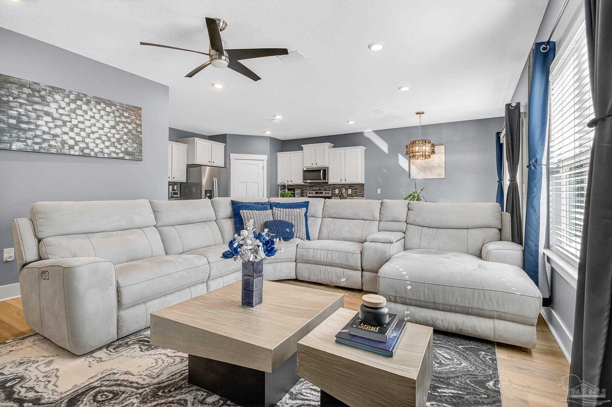 6076 Rutherford Loop Pensacola, FL 32526 - Photo 25 of 67 a living room with furniture and a view of kitchen