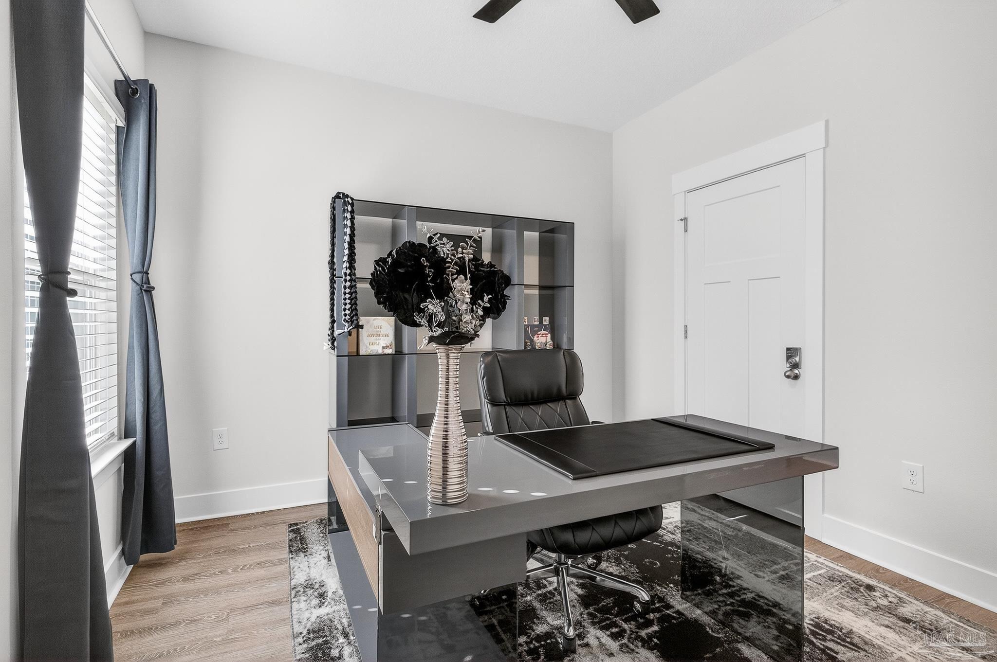 6076 Rutherford Loop Pensacola, FL 32526 - Photo 28 of 67 a living room with a table and chairs
