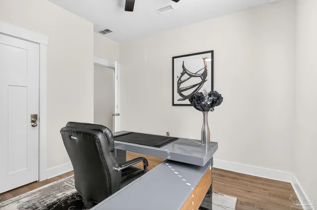 a bedroom with a bed and a ceiling fan