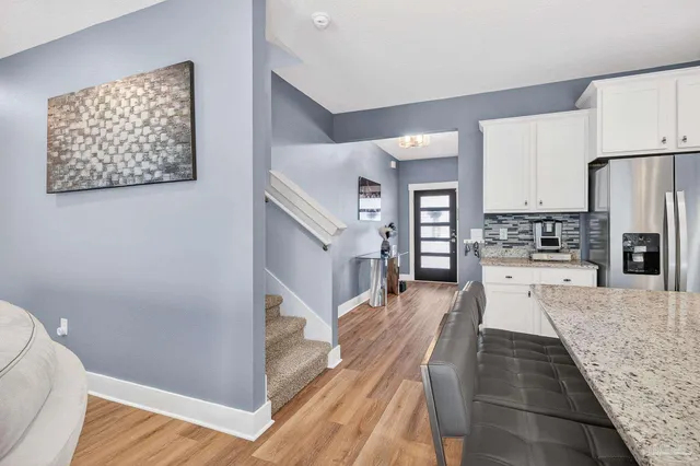 a large bed sitting in a bedroom next to a wall